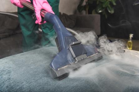 bloomington-carpet-cleaners-staff-vacuuming-sofa-upholstery